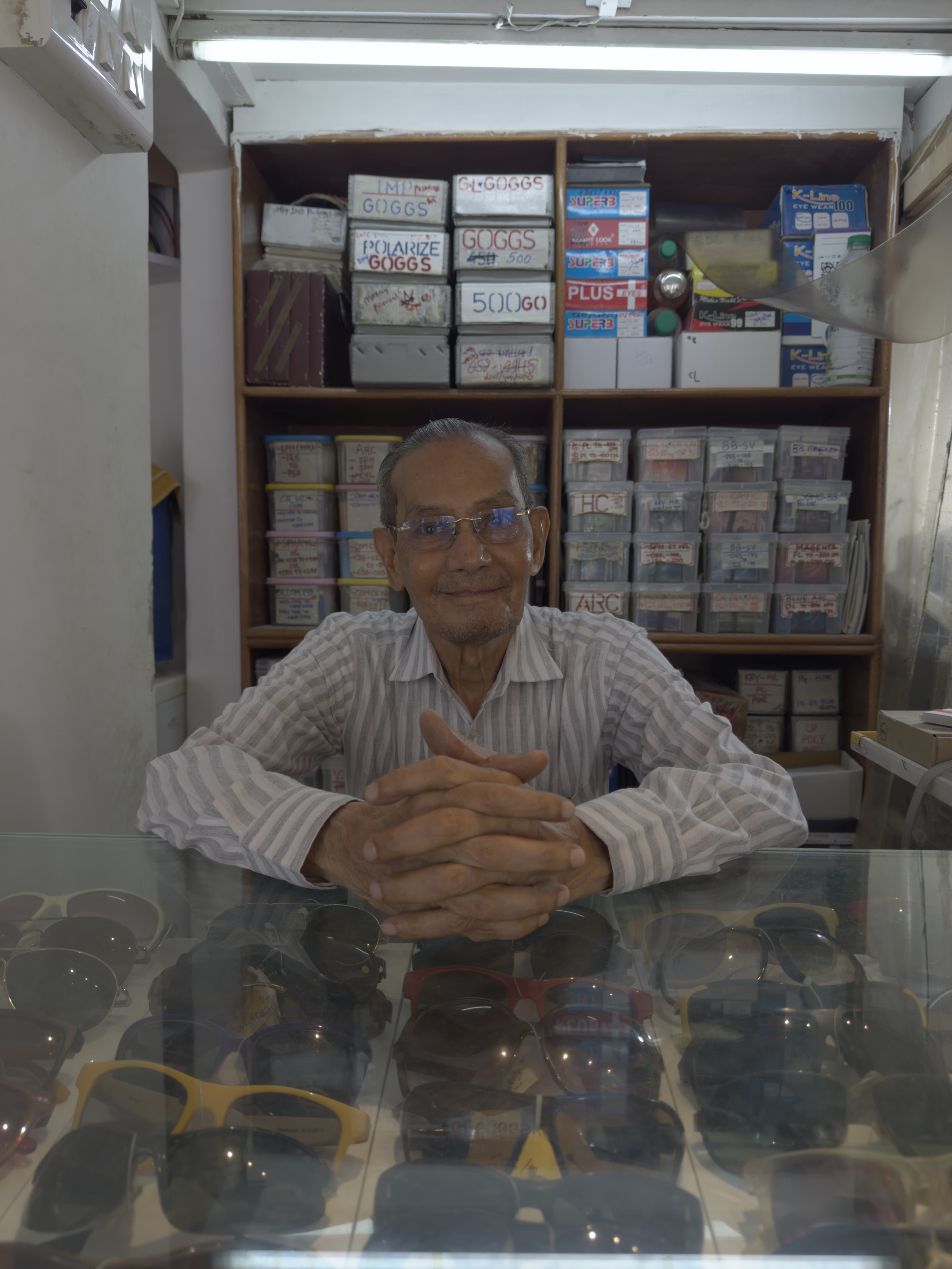 Vinodchandra Vora, who began the family's life in optics, at the Ami Optics counter